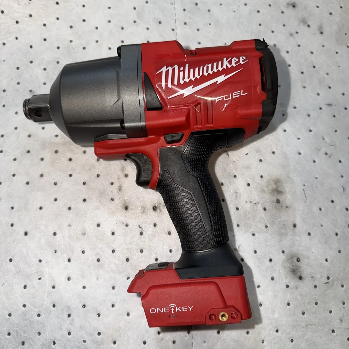Milwaukee M18 FUEL ONE-KEY impact wrench after refurbishment, with clean red housing and fresh labels